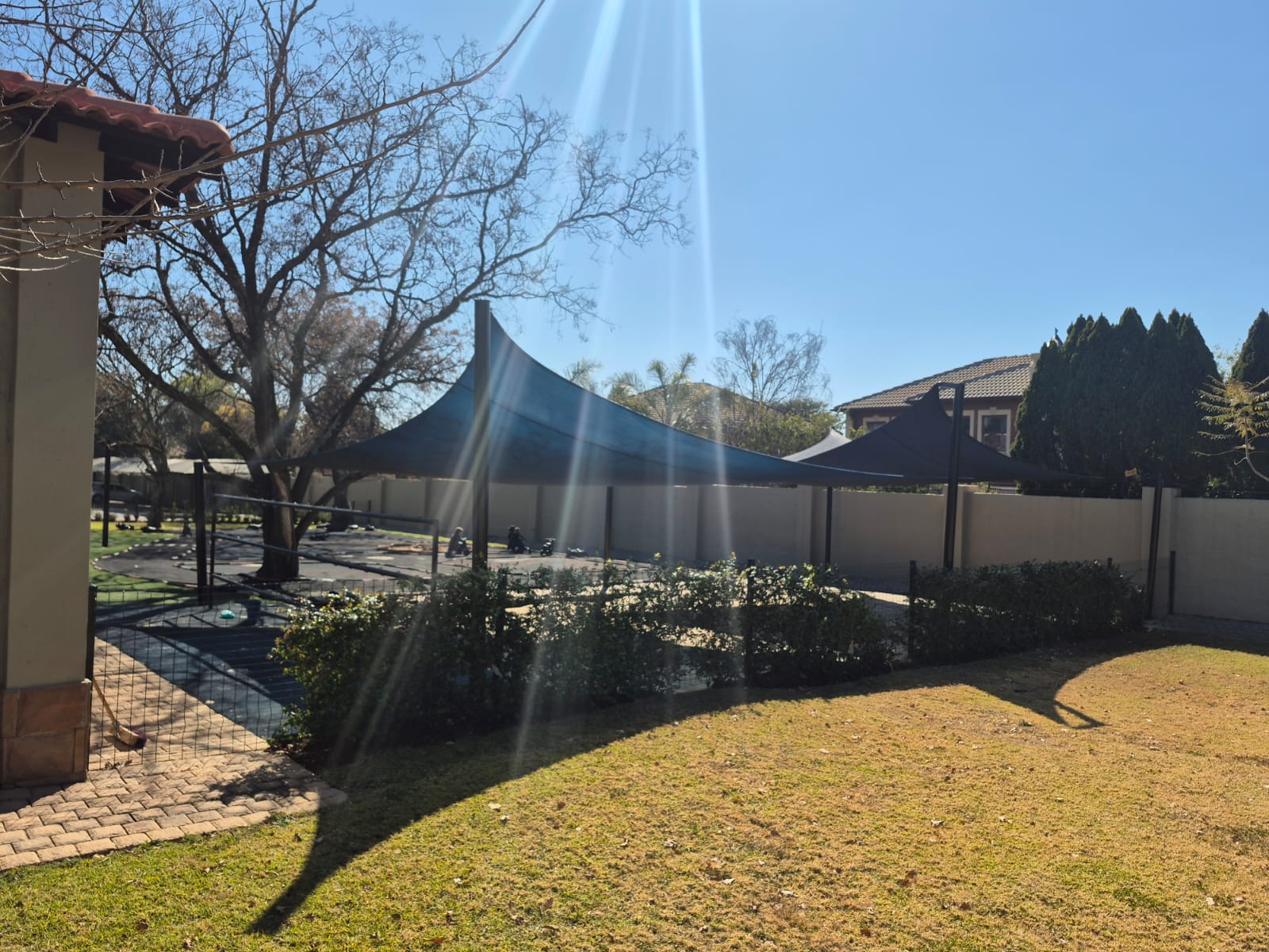 Custom tensioned shade net installation on a residential property
